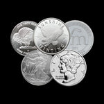Five silver coins with different designs on a black background