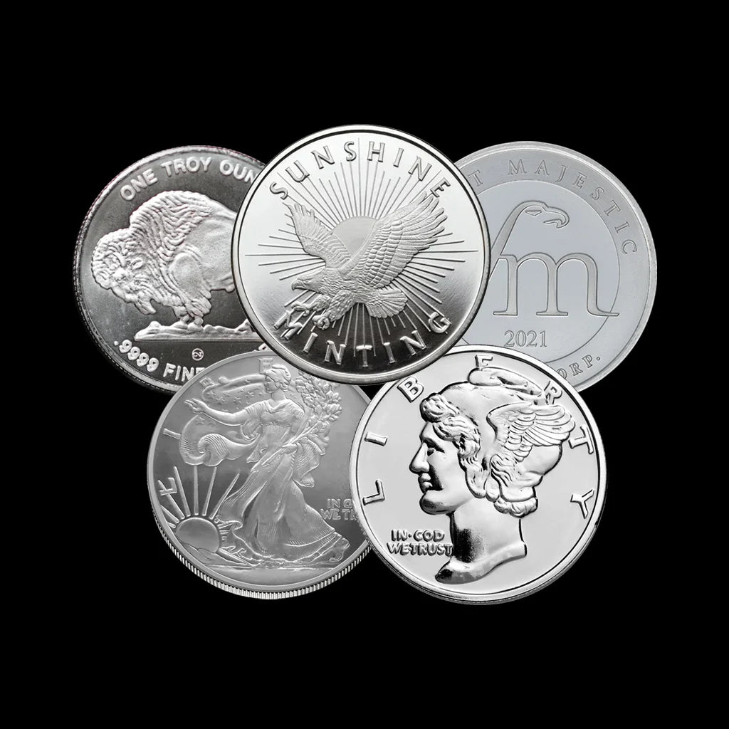 Five silver coins with different designs on a black background