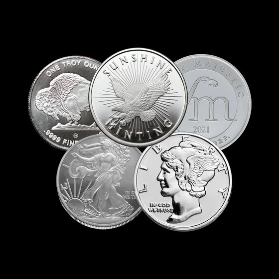 Five silver coins with different designs on a black background