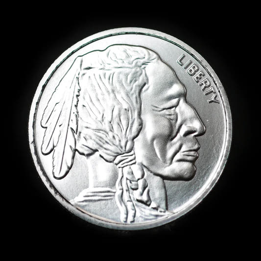 A 1 oz silver round with an embossed design featuring a profile of a Native American chief on one side and the image of a buffalo on the reverse, with the word 'LIBERTY' arched at the top.